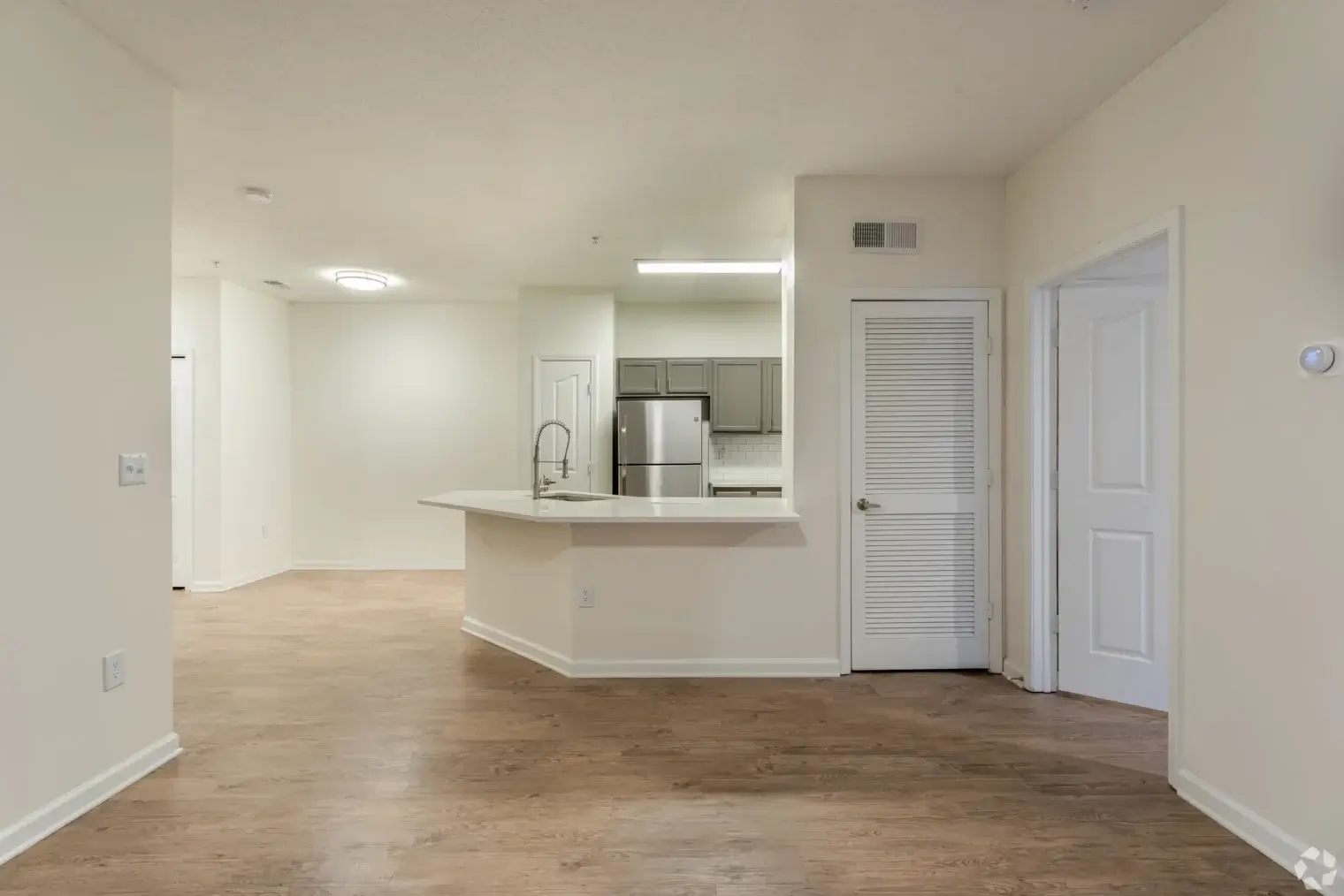 Open apartment interior with wood flooring and kitchen at Overlook Ridge Atlanta